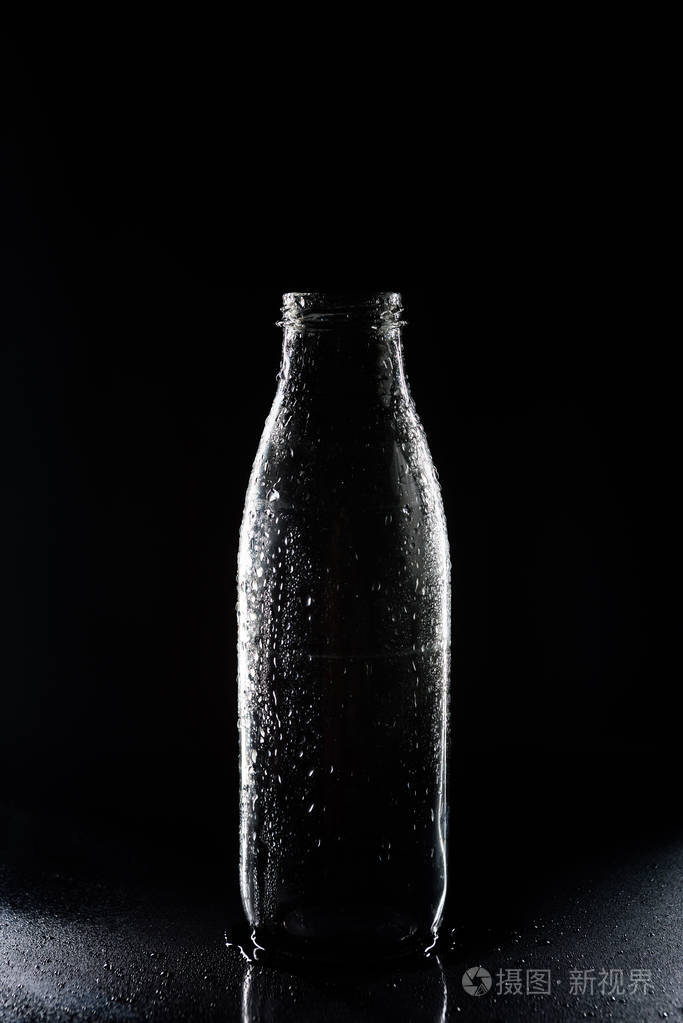 一个透明的空玻璃瓶里面有黑色的凝结水