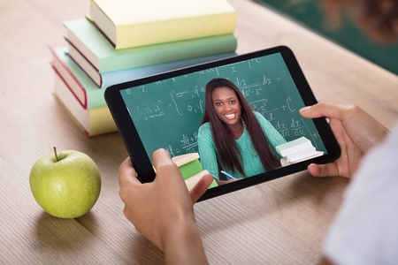 s Hand Video Conferencing With Female Teacher On Digital Tablet