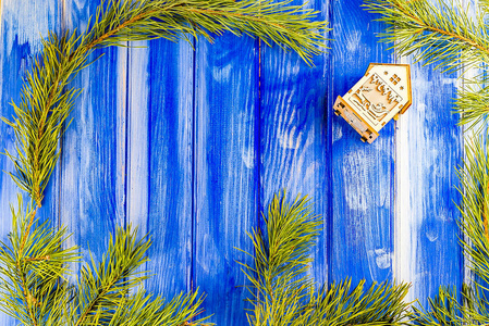 在一棵蓝树的背景上装饰松树的枝条和房子