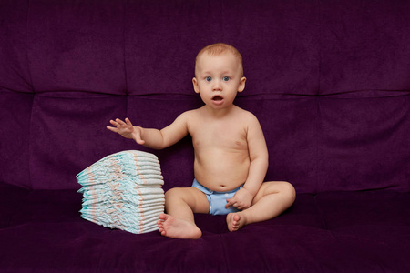 紫色背景的尿布或尿布叠的小男孩