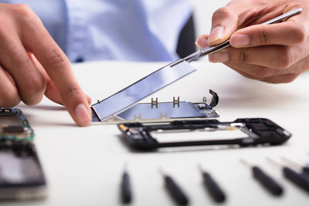 s Hand Fixing Damaged Screen On Mobile Phone