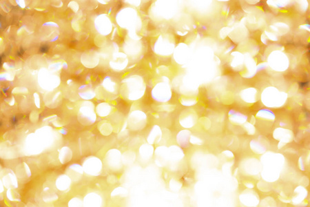 圣诞背景。 金色假日抽象闪光离焦背景与闪烁的星星。 模糊的布