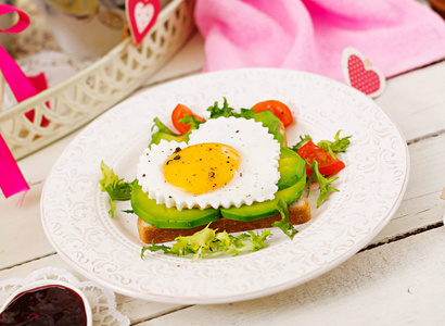 s Day  sandwich of fried egg in the shape of a heart, avocado a