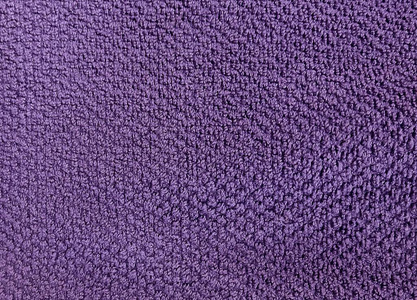面料和纺织品关闭紫色棉巾或特里纹理背景与复制空间的文字装饰。