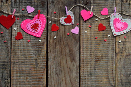s Day background with handmade felt hearts, clothespins. Valenti