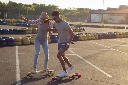 幸福的年轻夫妇有滑板的概念，幸福，爱和青春。