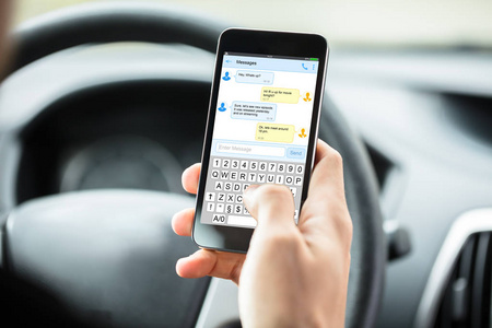 s Hand With Mobilephone Text Messaging Inside Car