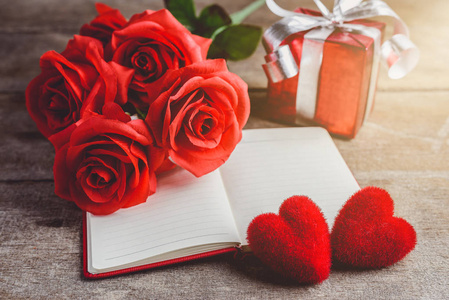 红玫瑰, 红心, 笔记本和礼品盒上的木 backgrou
