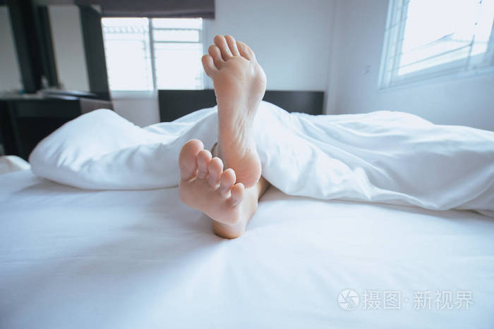 双脚并拢醒来后在床上懒懒地伸展