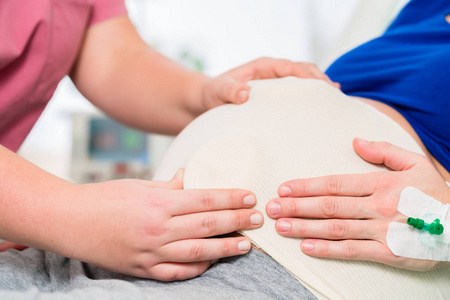 助产士或护士感觉怀孕妇女的婴儿肚