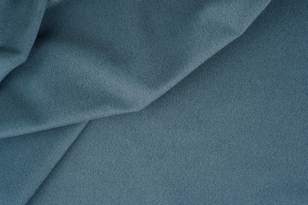 把一个蓝色的羊毛织物合上。抽象背景