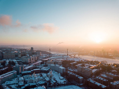 s eye view to a winter city at dawn in the fog