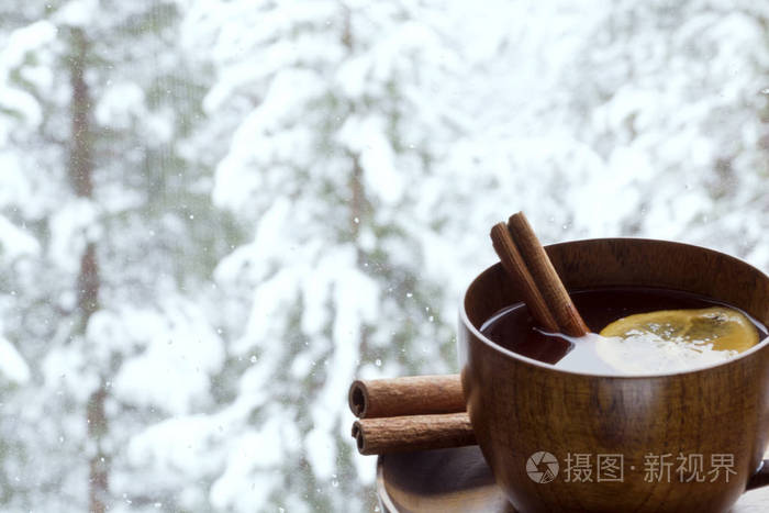 窗台上的芳香茶一杯。白雪皑皑的丛林，从窗口的视图