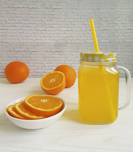 新鲜的橙色新鲜透明玻璃与一管白色木制