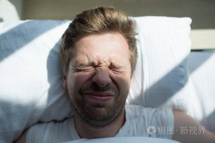 白种人在白色t恤衫的成熟男人不想起床在早上