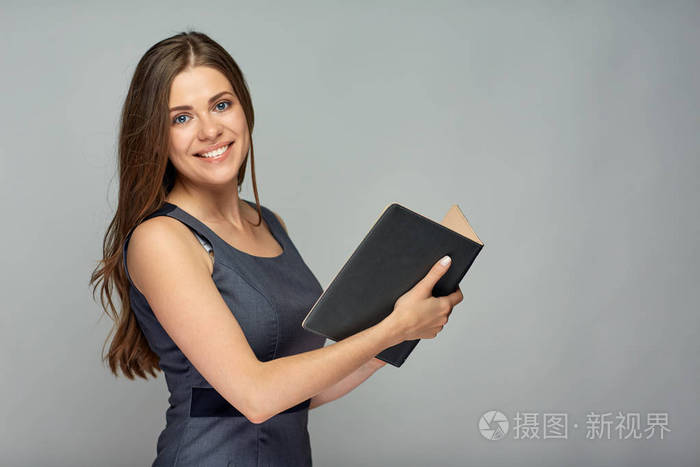 美丽的女教师拿着书,在灰色背景下摆姿势照片-正版商用图片11jtrb-摄