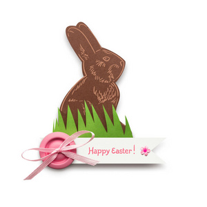 创意复活节概念照片一只兔子在草地上用纸做的白色背景。