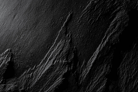 页岩黑色页岩板块宏观自然背景的浮雕纹理照片