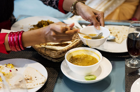 s hands having Indian food