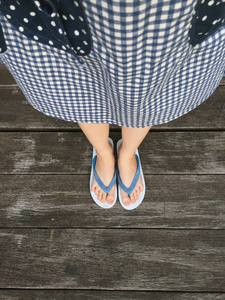 蓝色鞋子隔离在木地板上，以供俯视。 女人穿着蓝色翻盖和蓝色苏格兰礼服在木地板背景上，非常适合任何用途。