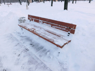 公园里的一张长凳是由一层大的雪带来的
