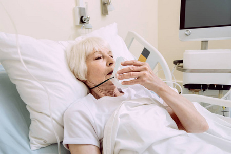 伤心女人在医院摘氧气面罩