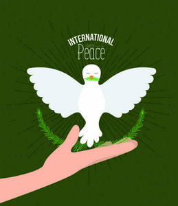 绿色彩色海报与火花和手捧着一只鸽子与橄榄枝在山顶与装饰的叶子的半