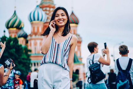 s Cathedral, international female tourist using roaming mobile c