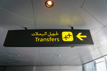 机场转机标志国际航班转机黄色标志机场英语和阿拉伯语照片