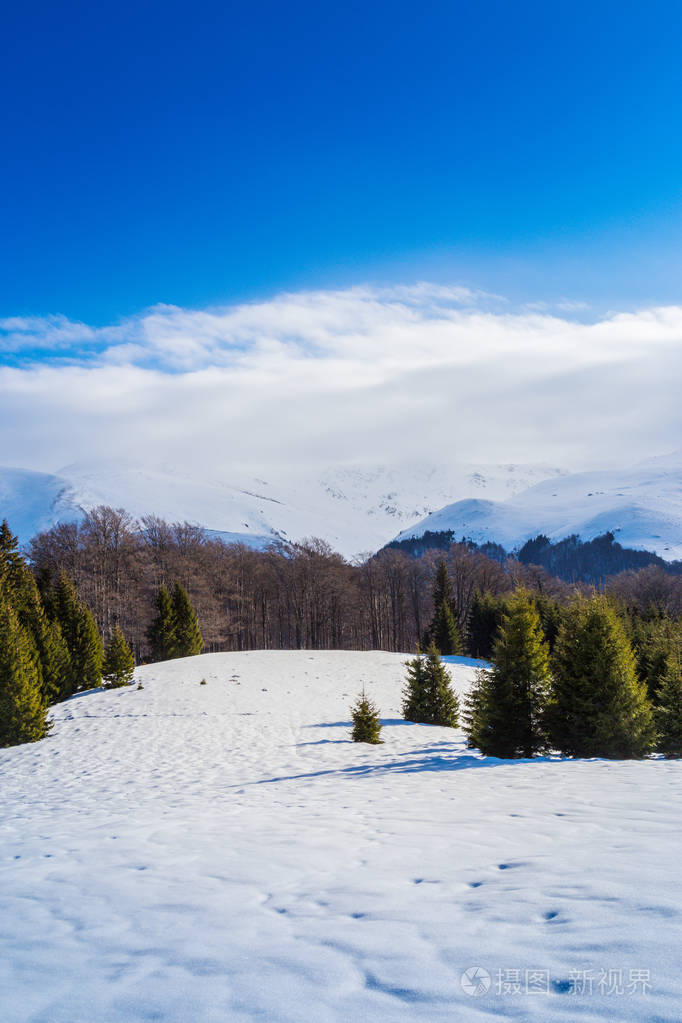 美丽的冬天的景色冰封的雪和蓝天在山上