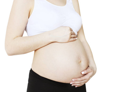  black yoga pants, arms on her belly. Female hands wrapped aroun