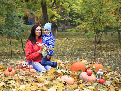 s day, happy mother with her son in the park, golden autumn