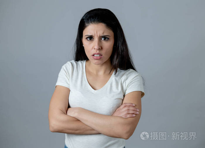 特写一个有吸引力的年轻拉丁女人的肖像脸上带着愤怒的表情看着愤怒和