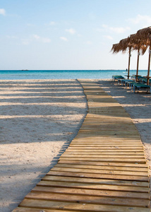 希腊克里特岛埃拉弗尼斯海滩上的雨伞和日光浴床