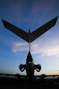 s tail with the engines at the airport against the sky with clou