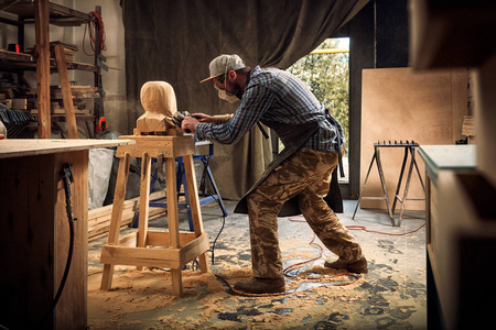 s head, using an angle grinder  in the workshop, around a lot of