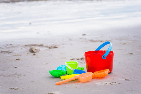 s beach toys  buckets, spade and shovel on sand on a sunny day