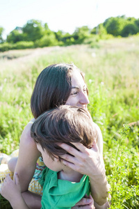 s smile. A child is hugging mother. Portrait of a girl.