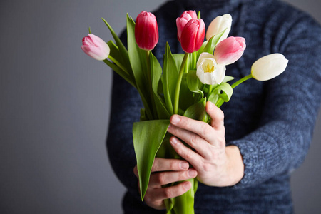 s hands. Studio light. Soft focus. Spring flowers, pink, white a