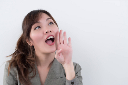 portrait of happy smiling asian woman shouting or screaming to 