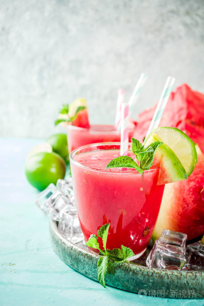 水果夏季冷饮自制西瓜汁或冰沙配以石灰和新鲜薄荷叶淡蓝色时尚背景