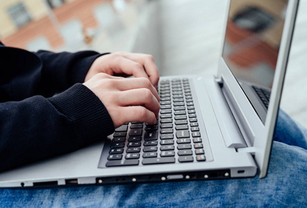 s hands typing on laptop computer outdoors, Closeup. Technology 