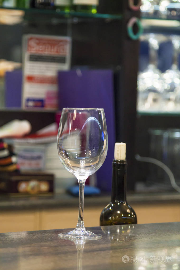 酒吧柜台的酒杯和一瓶酒