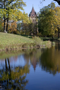 秋天的树，有着明亮的叶子，反映在湖里和古建筑遗址里