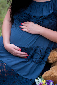 s belly. Pregnant woman hugging her tummy