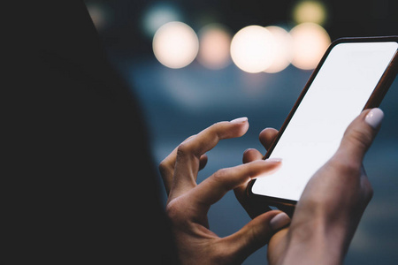 s hands holding telephone and chatting online in social networks