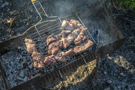 烤肉时煮熟的烤肉。 烧烤新鲜牛肉肉切片。