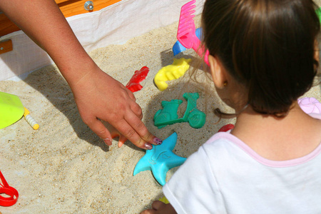 s hand on the left, toys middle.