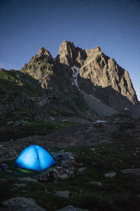 Ossau 2884 m with summer sky and a blue tent in the foreground