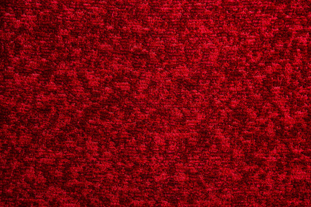 深红色地毯的质地.渐变光的特写照片